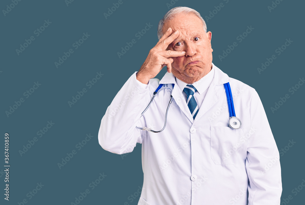 Senior handsome grey-haired man wearing doctor coat and stethoscope worried and stressed about a problem with hand on forehead, nervous and anxious for crisis Senior handsome grey-haired man wearing doctor coat and stethoscope worried and stressed about a problem with hand on forehead, nervous and anxious for crisis