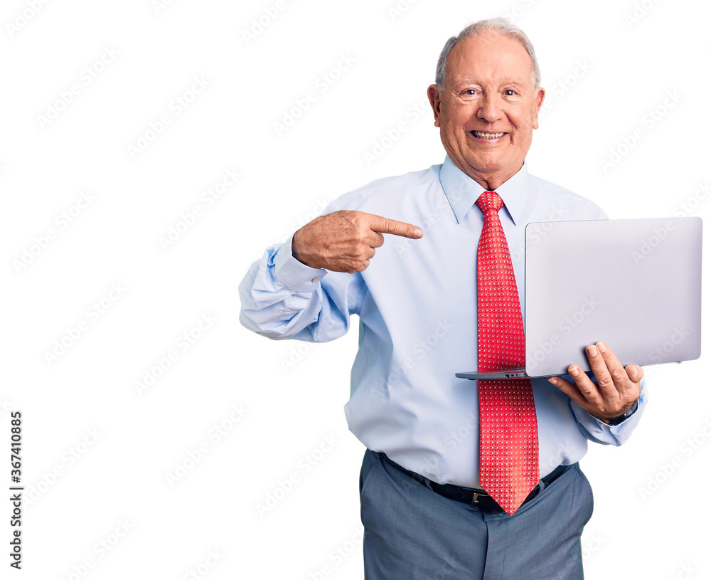 Senior handsome grey-haired man wearing tie using laptop pointing finger to one self smiling happy and proud Senior handsome grey-haired man wearing tie using laptop pointing finger to one self smiling happy and proud