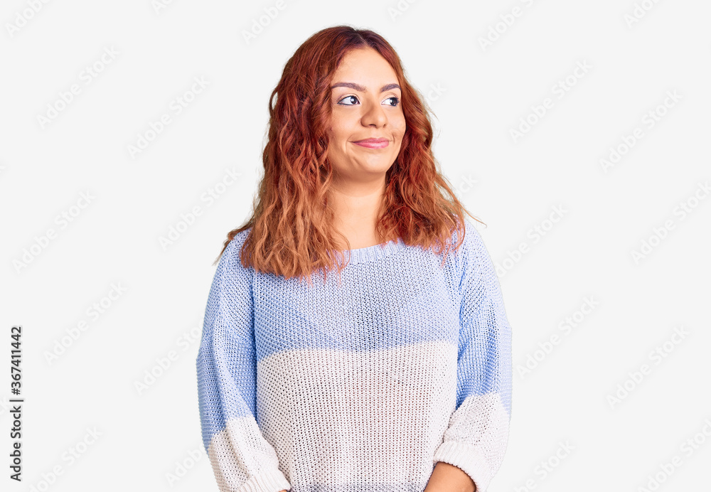 Young latin woman wearing casual clothes smiling looking to the side and staring away thinking. Young latin woman wearing casual clothes smiling looking to the side and staring away thinking.