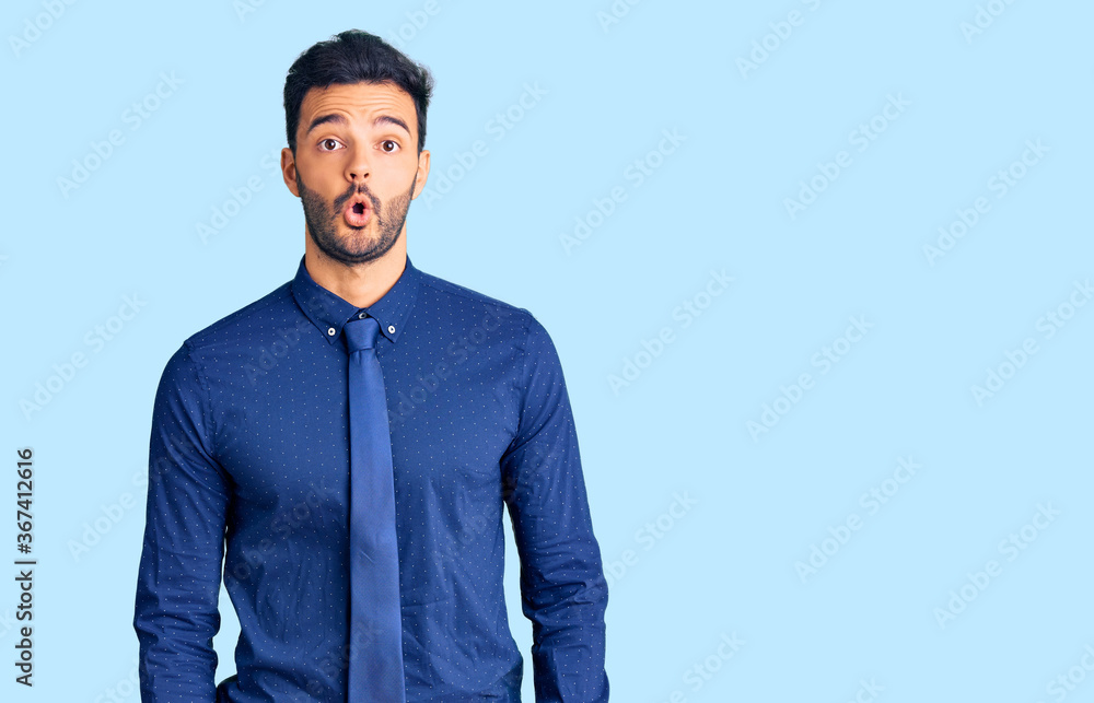 Young handsome hispanic man wearing business clothes scared and amazed with open mouth for surprise, disbelief face Young handsome hispanic man wearing business clothes scared and amazed with open mouth for surprise, disbelief face