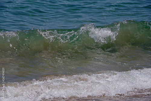 Close-up view of wave water at a Pacific Ocean beach in Santa Barbara, California on a summer day