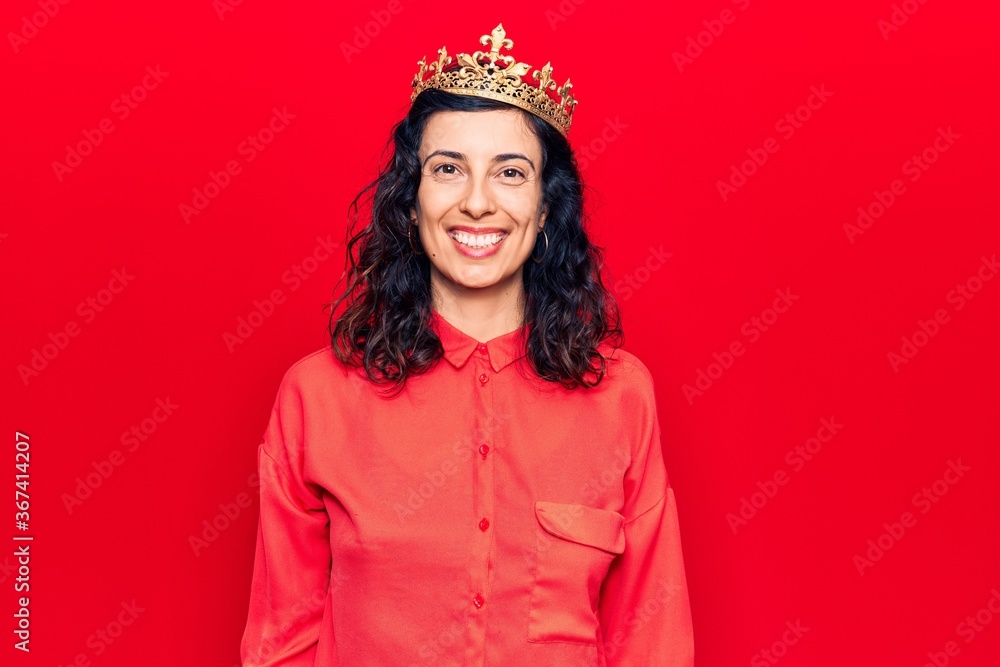 Fototapeta premium Young beautiful hispanic woman wearing princess crown with a happy and cool smile on face. lucky person.