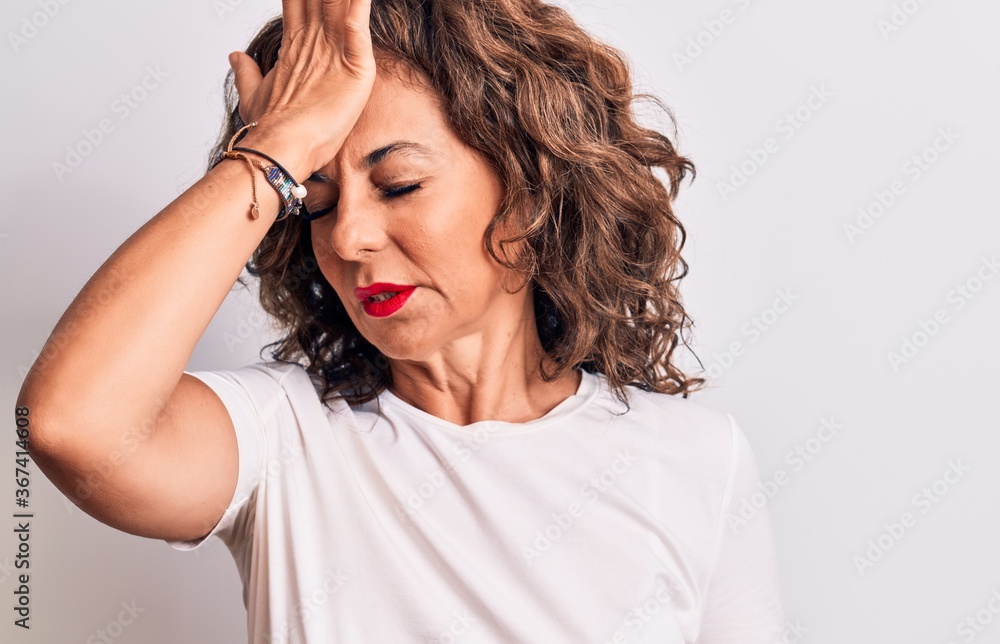 Middle age beautiful brunette woman wearing casual t-shirt standing over white background surprised with hand on head for mistake, remember error. Forgot, bad memory concept. Middle age beautiful brunette woman wearing casual t-shirt standing over white background surprised with hand on head for mistake, remember error. Forgot, bad memory concept.