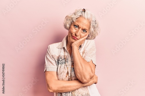 Senior grey-haired woman wearing casual clothes thinking looking tired and bored with depression problems with crossed arms.