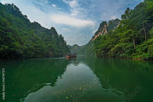 Tourist boat sailing among karst landscape on Baofeng Lake