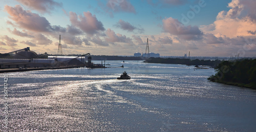 A tugboat heading down the Savannah River in the late afternoon lightg photo