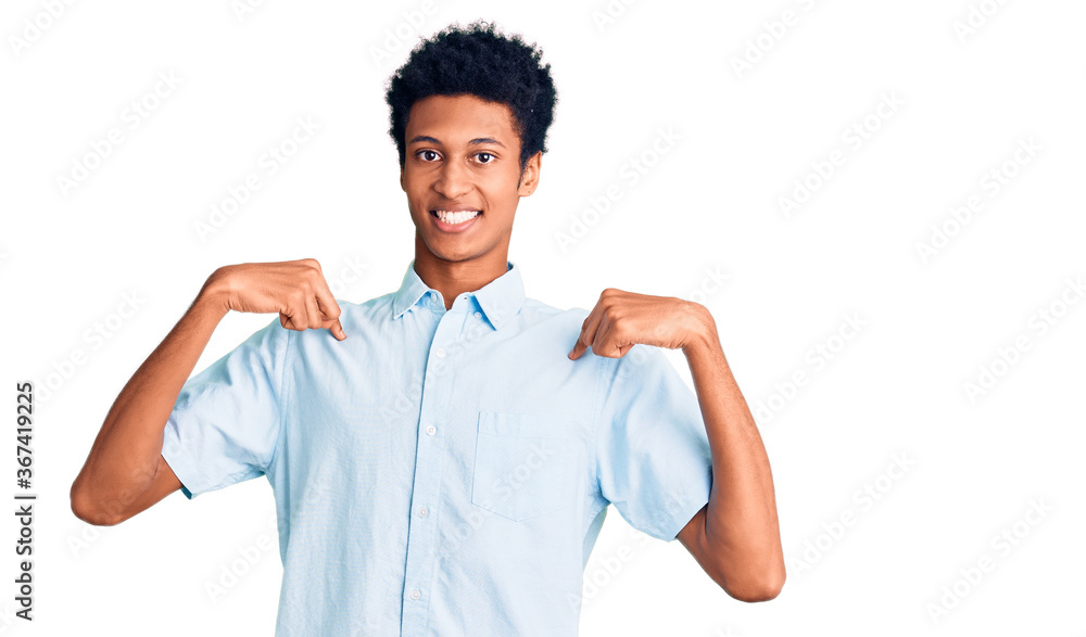 Young african american man wearing casual clothes looking confident with smile on face, pointing oneself with fingers proud and happy. Young african american man wearing casual clothes looking confident with smile on face, pointing oneself with fingers proud and happy.