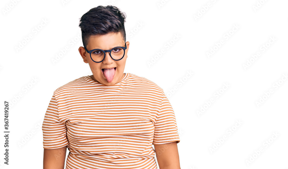 Little boy kid wearing casual clothes and glasses sticking tongue out happy with funny expression. emotion concept. Little boy kid wearing casual clothes and glasses sticking tongue out happy with funny expression. emotion concept.