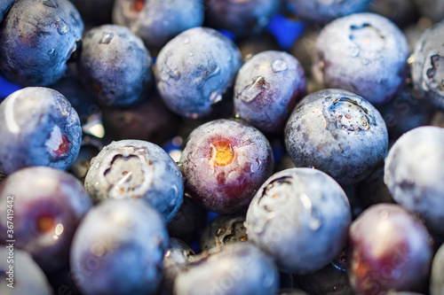 Close up view of blueberries washed with water.