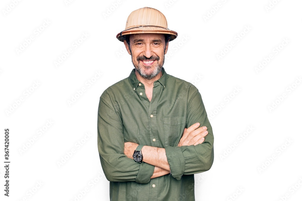 Middle age tourist man on vacation wearing explorer hat over isolated white background happy face smiling with crossed arms looking at the camera. Positive person. Middle age tourist man on vacation wearing explorer hat over isolated white background happy face smiling with crossed arms looking at the camera. Positive person.