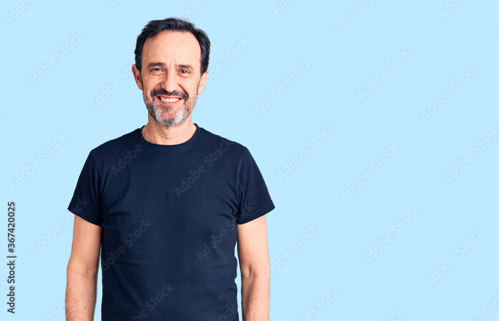Obraz premium Middle age handsome man wearing casual t-shirt with a happy and cool smile on face. lucky person.