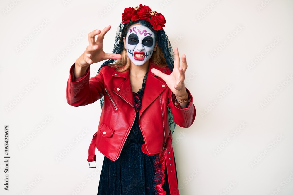 Woman wearing day of the dead costume over white shouting frustrated with rage, hands trying to strangle, yelling mad Woman wearing day of the dead costume over white shouting frustrated with rage, hands trying to strangle, yelling mad