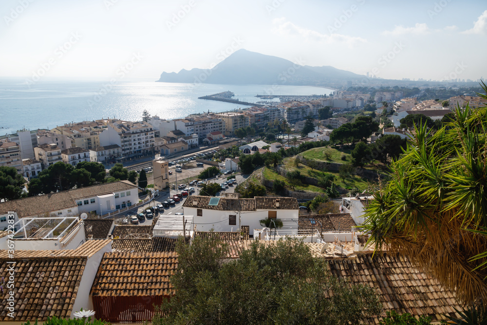 Sunlit coast with mountain and view over Altea with harbour, Costa Blanca, Spain
