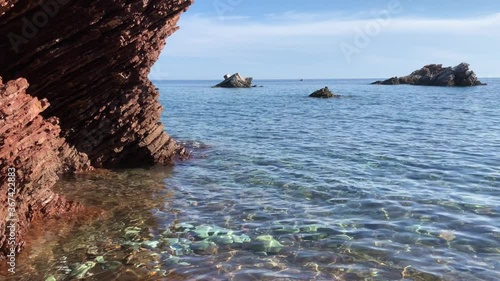 Green calm sea with red rocks. Crvena Glavica, Montenegro  photo