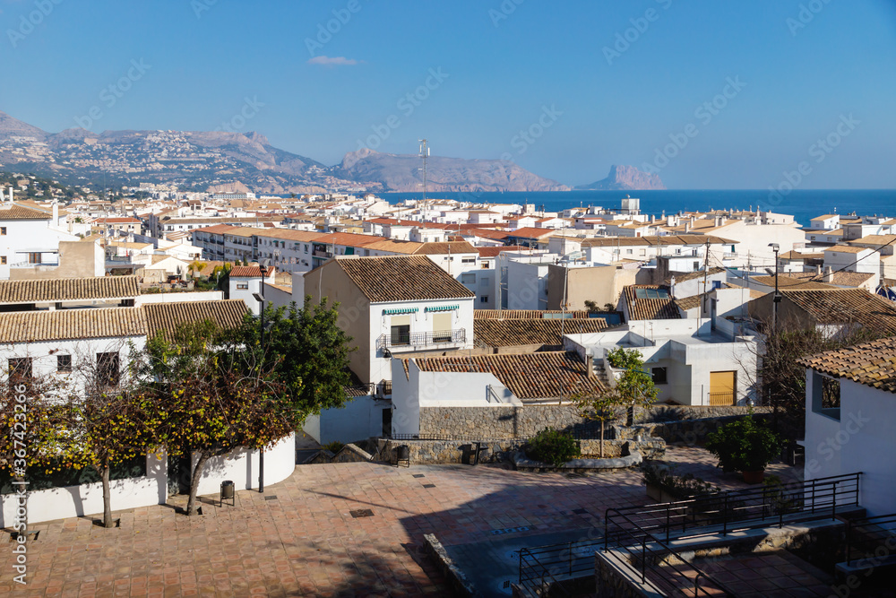 Outlook at the old town square Placa l'Aigua with view over skyline and ocean with mountains and rock of Calpe, Altea, Costa Blanca, Spain