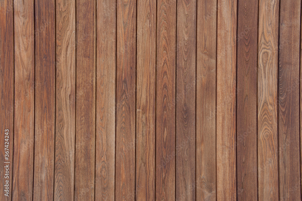 Rich colored clean dark wooden vertical panel slats background with even lighting. Rich colored clean dark wooden vertical panel slats background with even lighting.