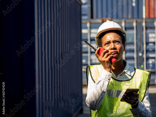 Foreman engineering african is talk telephone about for work shipping import export cargo warehouse international.Female wear hat white and safety green factory company 