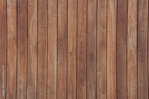 Rich colored clean dark wooden vertical panel slats background with even lighting.