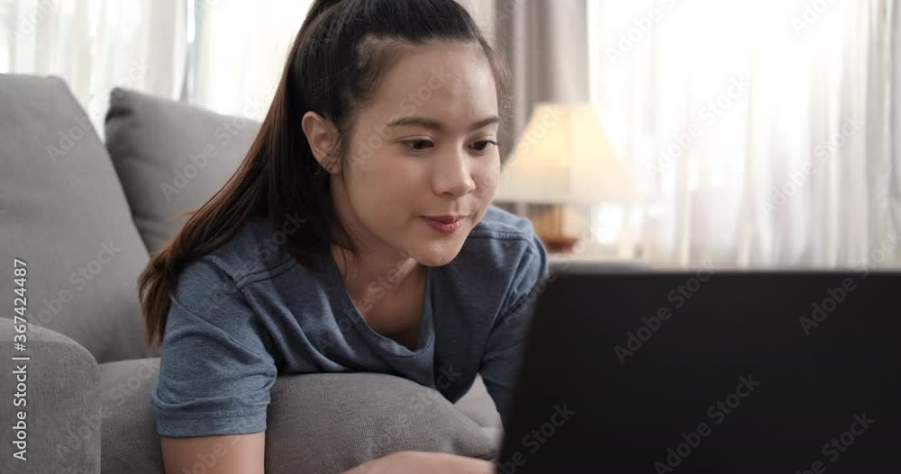 Sporty young asian woman watching fitness video tutorial online concept.