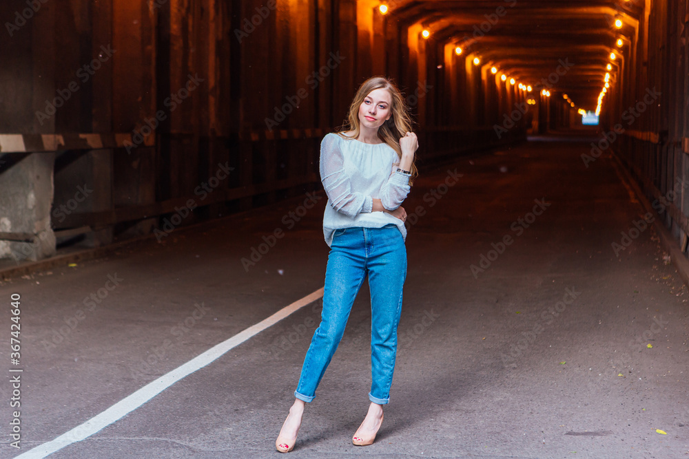 Young girl standing in a tunnel with lights