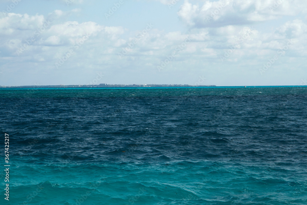 Natural texture. View of the turquoise color water ocean, sea waves and horizon in the Caribbean.