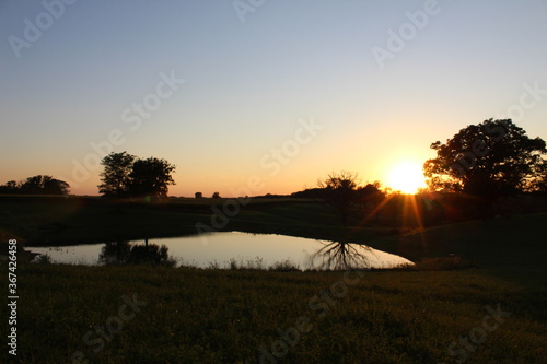 Sunset over farm lake
