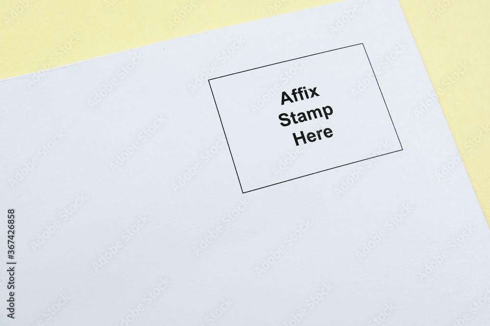 'Affix stamp here' printed on the top right hand corner of a white envelope against a yellow