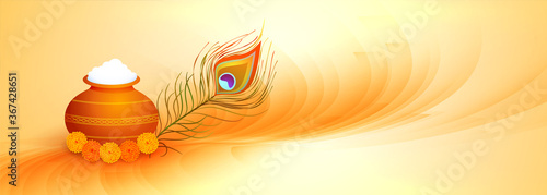 happy janmashtami banner with dahi handi and peacock feather
