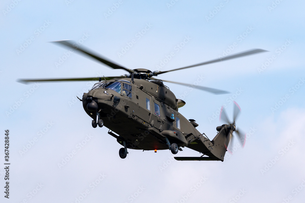 Fototapeta premium Large green army helicopter coming in to land.
