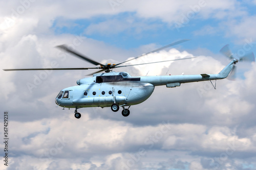Light blue military cargo helicopter flying.