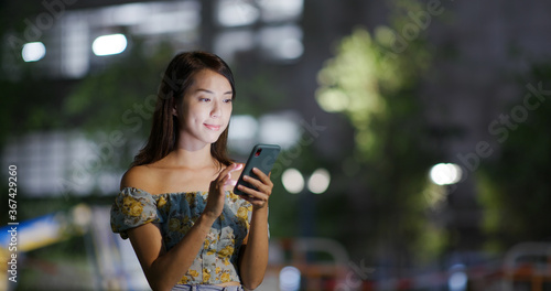 Wallpaper Mural Woman use of mobile phone in city at night Torontodigital.ca