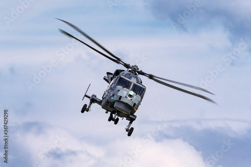 Modern military helicopter flying towards the camera.
