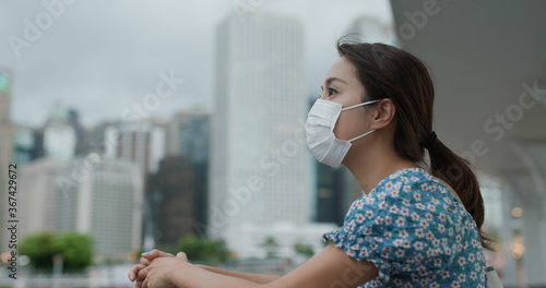 Photography Woman wear face mask and look at the city