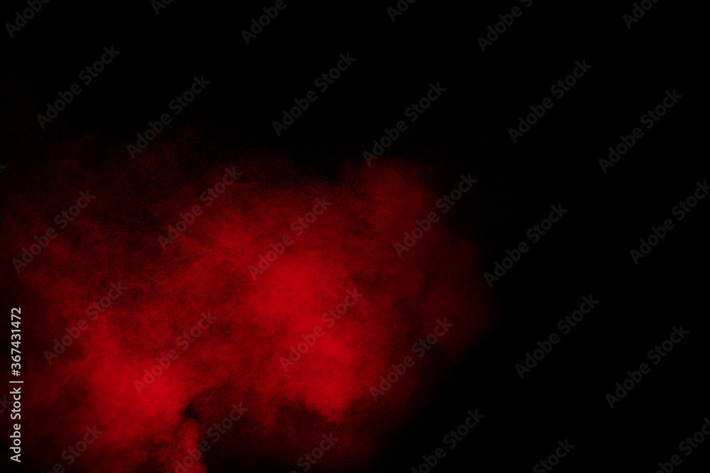 Red powder explosion cloud on black background. Freeze motion of red color dust particles splashing. Red powder explosion cloud on black background. Freeze motion of red color dust particles splashing.