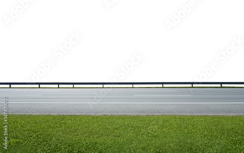 Asphalt road with railings and green grass photo