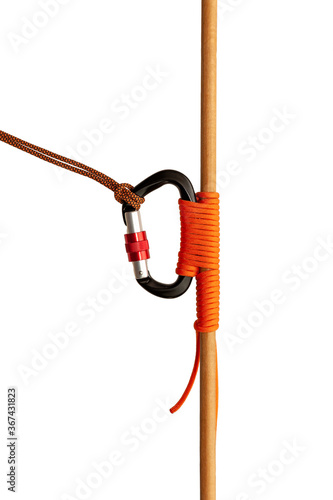 Carbine tied with a rope to a wooden bar close up