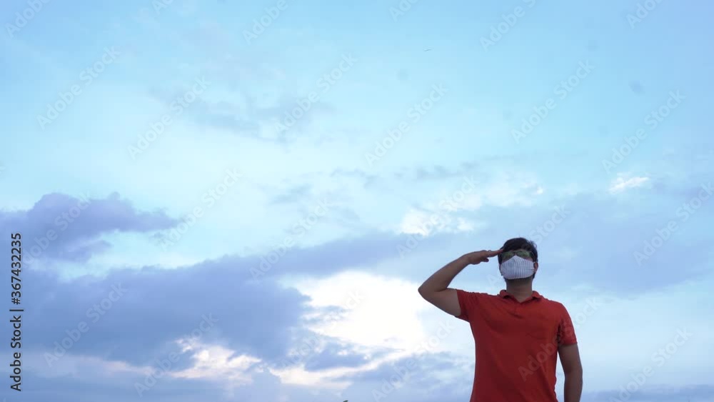 Young man giving salute in mask to India on Indian independence day Young man giving salute in mask to India on Indian independence day