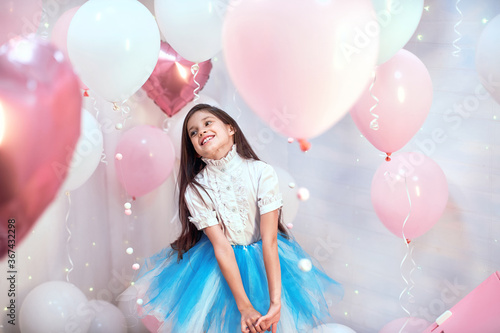 Happy celebration of birthday party with pink helium balloons cute little girl