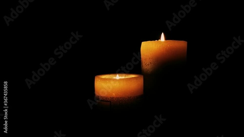 Two burnig candles wich are rotating photo