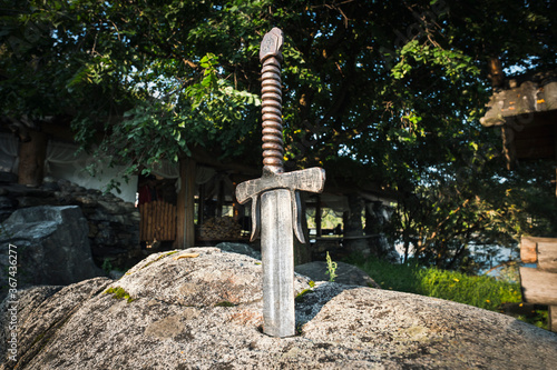 Excalibur, King Arthur's sword in stone. Edged weapons from the legend Pro king Arthur. photo