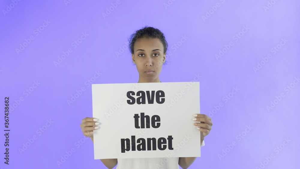 Afro-American Girl Activist With Save The Planet Poster on Violet background Afro-American Girl Activist With Save The Planet Poster on Violet background