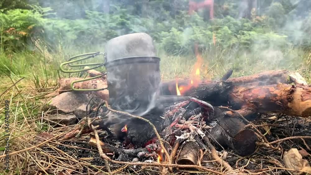 Cooking on campfire, Highlands, Scotland Cooking on campfire, Highlands, Scotland