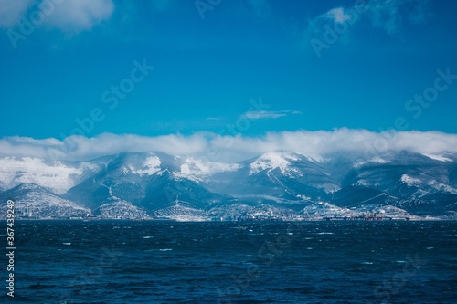 sea on the background of snow-capped mountains in winter