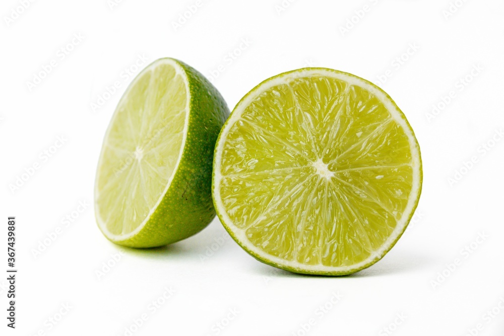 Bright juicy sour lime on a white background cut in half. Bright juicy sour lime on a white background cut in half.