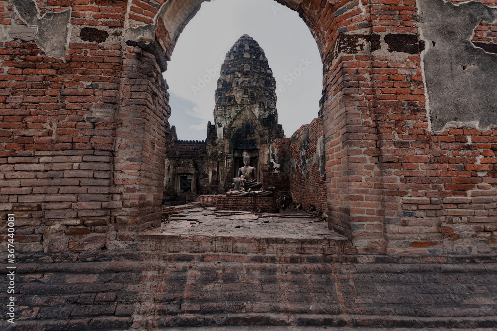 The old castle and the Buddha statue are made of stone. There are many monkeys The old castle and the Buddha statue are made of stone. There are many monkeys