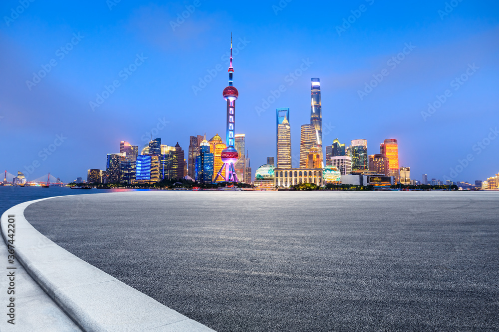 Empty asphalt road and city skyline and buildings at night in Shanghai,China.