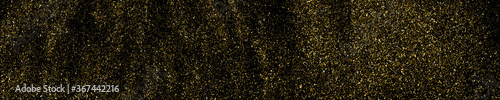 Gold glitter texture isolated on black. Amber particles color. Celebratory panoramic background. Golden explosion of confetti. Long horizontal banner. Vector illustration, EPS 10.