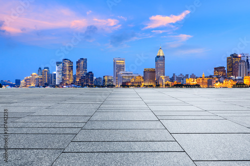 Empty square floor and city skyline with buildings at night in Shanghai,China.