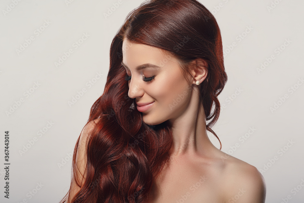 red-haired beautiful young woman on a light background