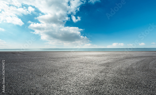 Asphalt square ground and river scene under blue sky. © ABCDstock